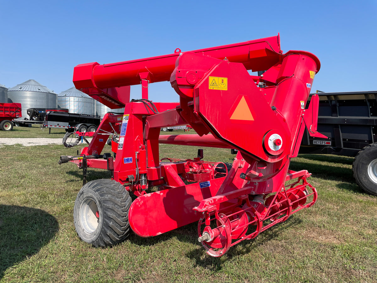 Akron EXG400X rear three-quarter view with pickup augers — predecessor-model reference photo for EXG480X