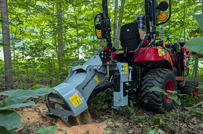 Baumalight 1P14 stump grinder working behind a subcompact tractor in woodland