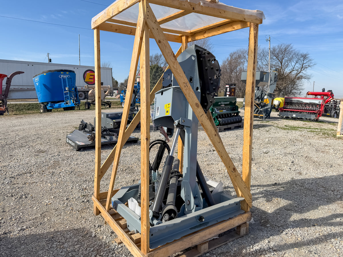 Baumalight 3P34 stump grinder upright in its shipping frame, showing cutter wheel and hydraulic lift linkage