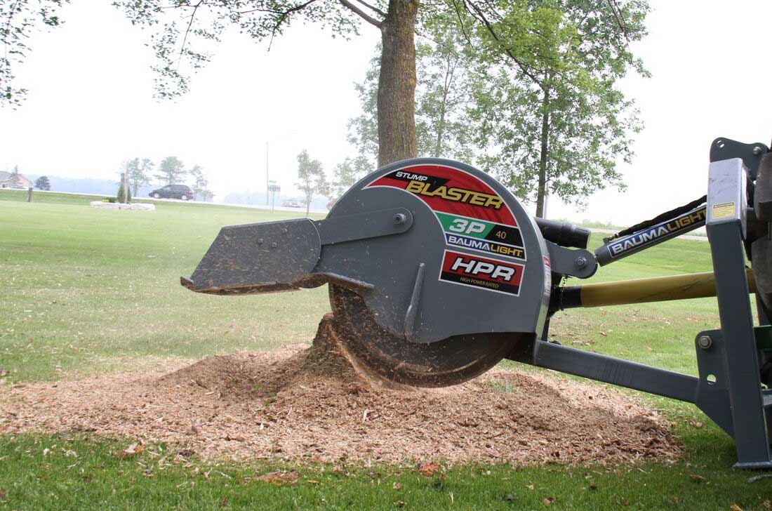 Baumalight 3P40 tractor stump grinder working across a stump, viewed from the cutter side