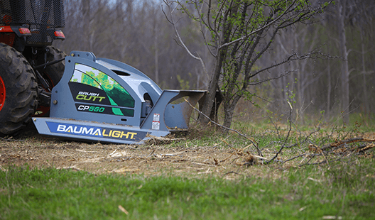 Baumalight CP560 brush cutter working at the base of a tree