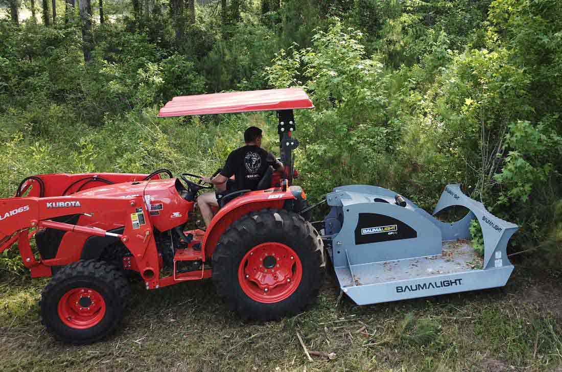 Baumalight CP572 brush cutter working beside a wooded area