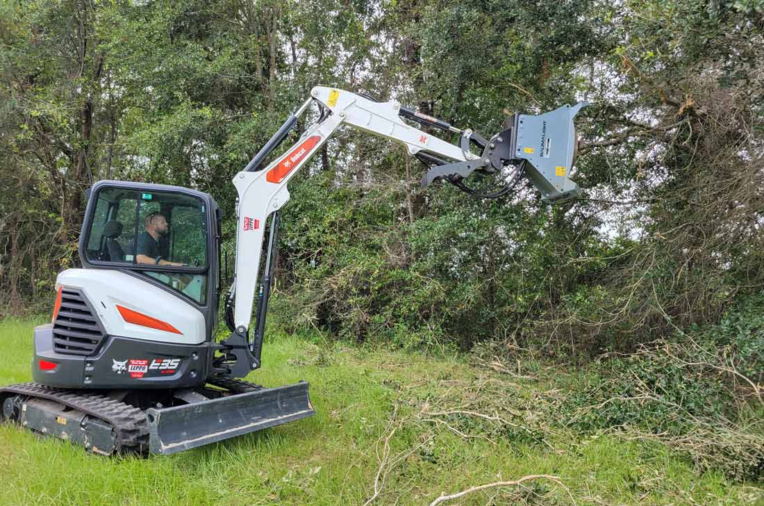 Baumalight CXC530 brush cutter on a mini excavator reaching into branches