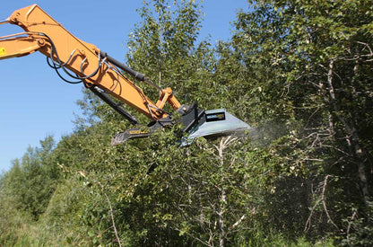 Baumalight CXC550 brush cutter reaching into branches from an excavator