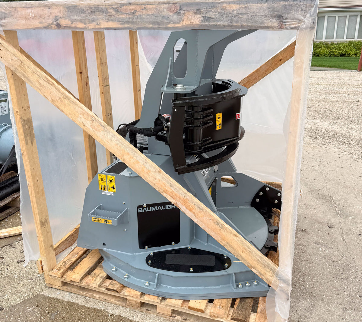 Baumalight FGS952 grapple saw in its shipping crate, whole-machine reference view