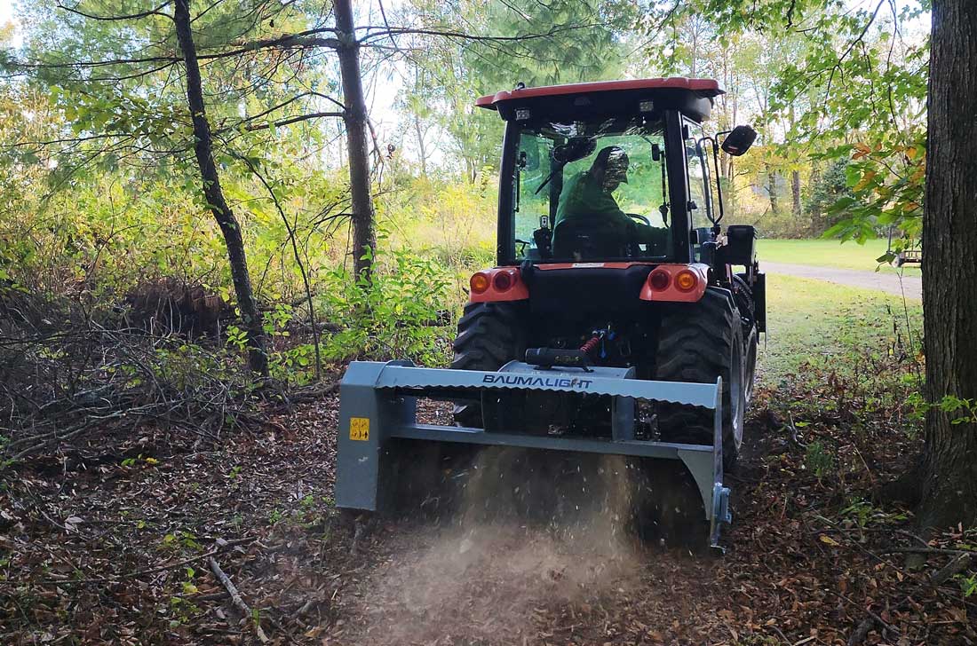 Rear view of a Baumalight MP360 three-point mulcher working behind a tractor