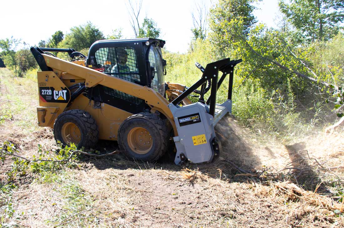 Baumalight MS1472 mulcher clearing brush with a skid steer
