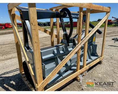 Baumalight MS972 skid steer mulcher in shipping crate, front-left view