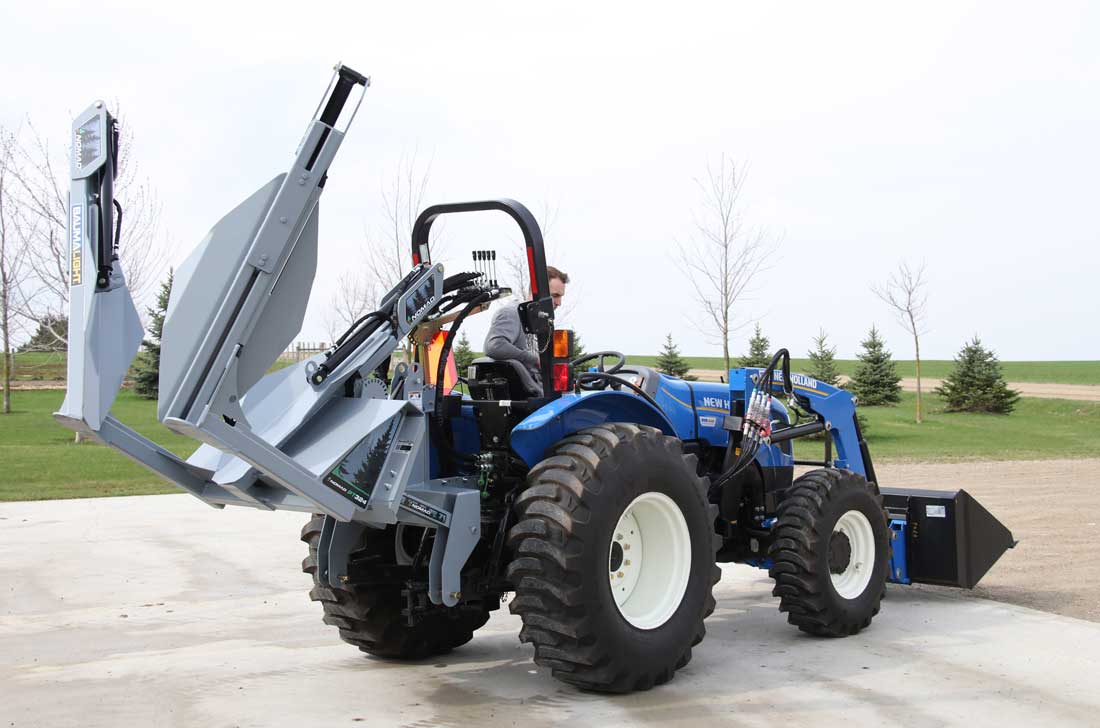 Baumalight PT324 tree spade raised behind a tractor, opposite side view