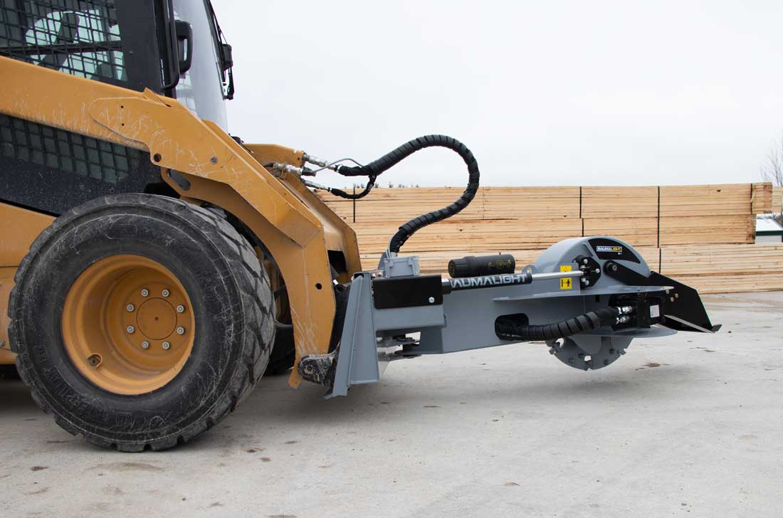 Side view of the Baumalight S22 grinder arm and cutting head on a skid steer