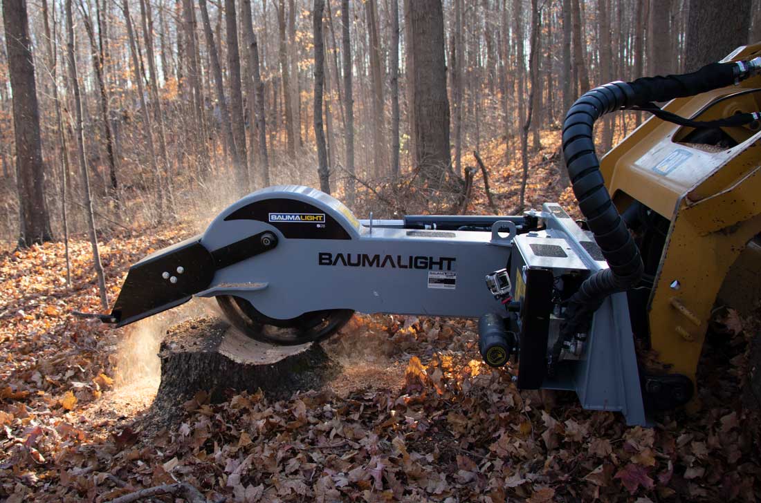 Side view of the Baumalight S28 cutting head working across a stump