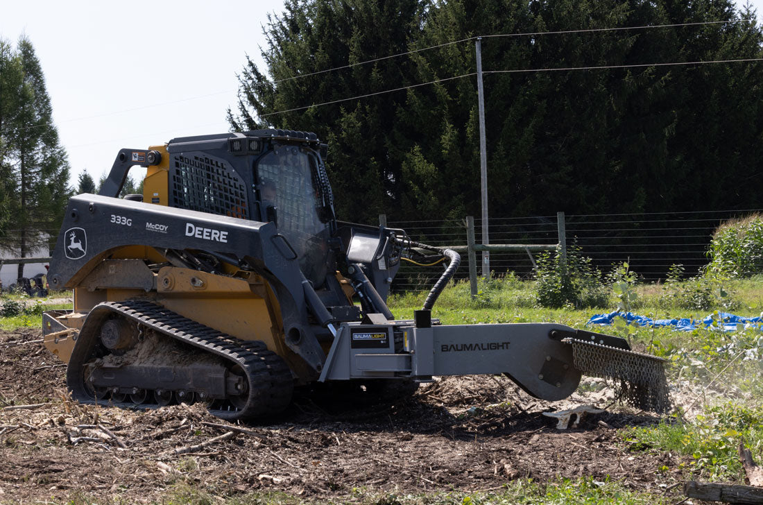 Baumalight S40 stump grinder working on a stump with a tracked skid steer