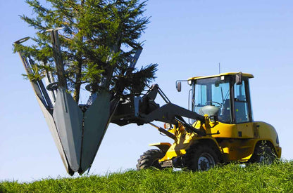 Baumalight ST650 six-blade tree spade lifting a tree and root ball on a wheeled loader
