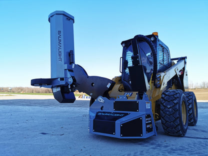Baumalight SWA550 boom mower with the flail head raised vertically beside a skid steer