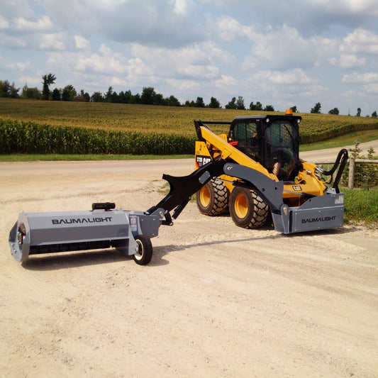 Baumalight SWF580 articulated boom mower with flail head lowered, front three-quarter view on a skid steer